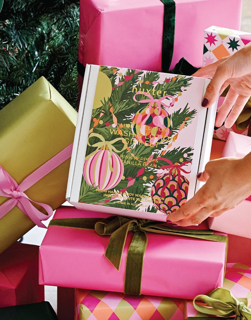 Huxter Christmas Wash and Lotion Gift Set styled with colourful gifts