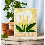 Jones & Co Market Wall Art featuring a beautiful lily floral design in vibrant colors on a textured background.