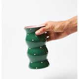 Jones & Co Palma Vase in green with pink dotty pattern, featuring a stylish ceramic design and a rounded shape.