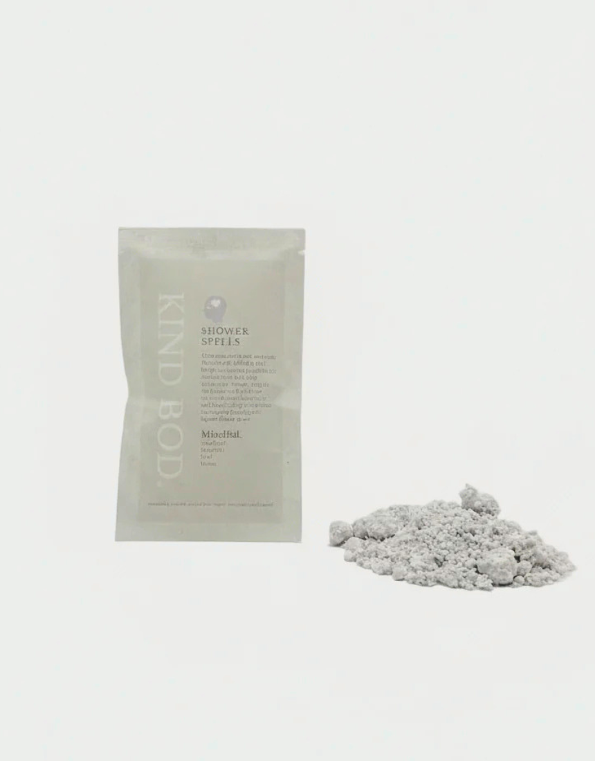 Kind Bod Shower Spells shower bomb with calming Zen scent, shown in a clear container with colorful bath tablet.