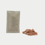 Kind Bod Shower Spells shower bomb with calming Zen scent, shown in a clear container with colorful bath salts and botanical accents.