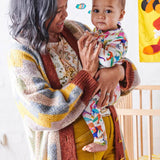 Dino Max white organic long sleeve zip romper for babies by Kip & Co, featuring a cute dinosaur print and soft fabric.