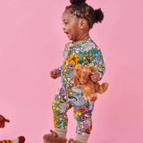 Kip & Co Bliss Floral organic long sleeve zip romper for babies, featuring colorful floral patterns and soft fabric.