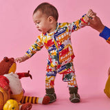 Kip & Co Big Wheels organic long sleeve zip romper for babies in playful wheel pattern, soft and comfy baby clothing.