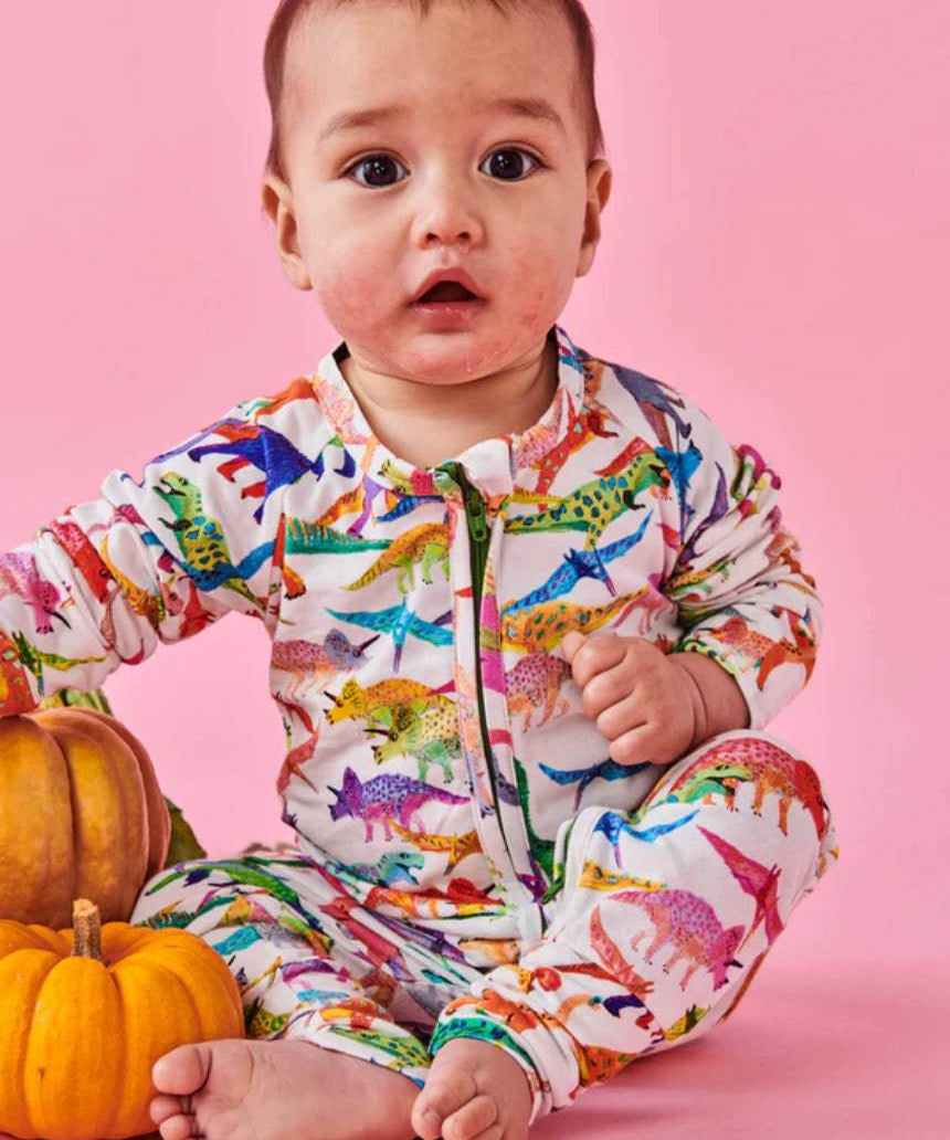 White organic long sleeve Dino Max romper by Kip & Co, featuring a zipper closure and playful dinosaur print for babies.