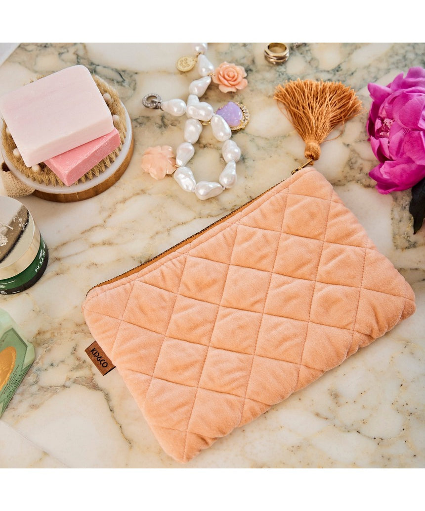Kip&Co velvet cosmetics purse in vibrant melon color, featuring a soft, plush texture and compact design for makeup essentials.