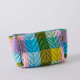 Kip&Co velvet toiletry bag in Sorbet Tartan with a soft, plush fabric and zip closure, designed for travel organization.