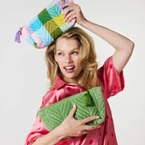 Kip&Co velvet toiletry bag in Sorbet Tartan with a soft fabric exterior and zipper closure, designed for travel storage.