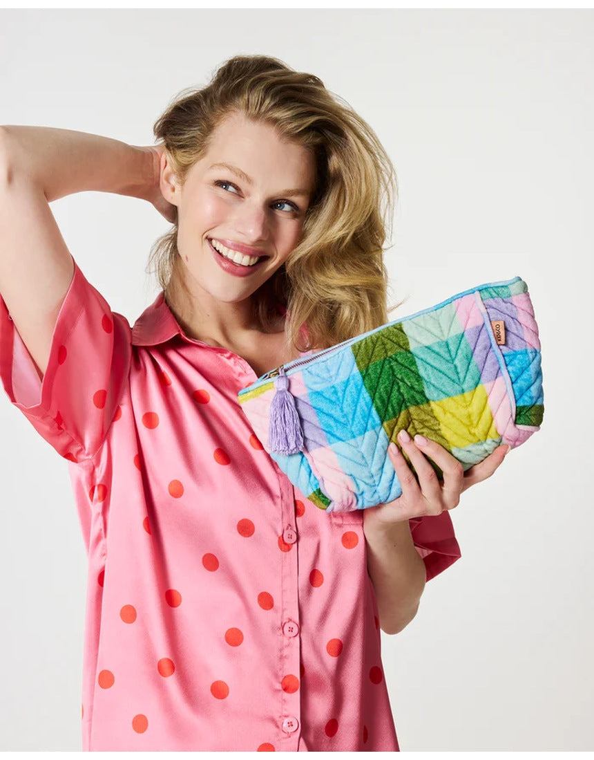 Kip&Co velvet toiletry bag in Sorbet Tartan pattern with zipper closure, showcasing soft fabric and compact storage design.