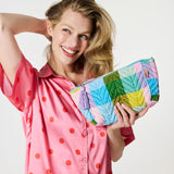 Kip&Co velvet toiletry bag in Sorbet Tartan pattern with zipper closure, showcasing soft fabric and compact storage design.