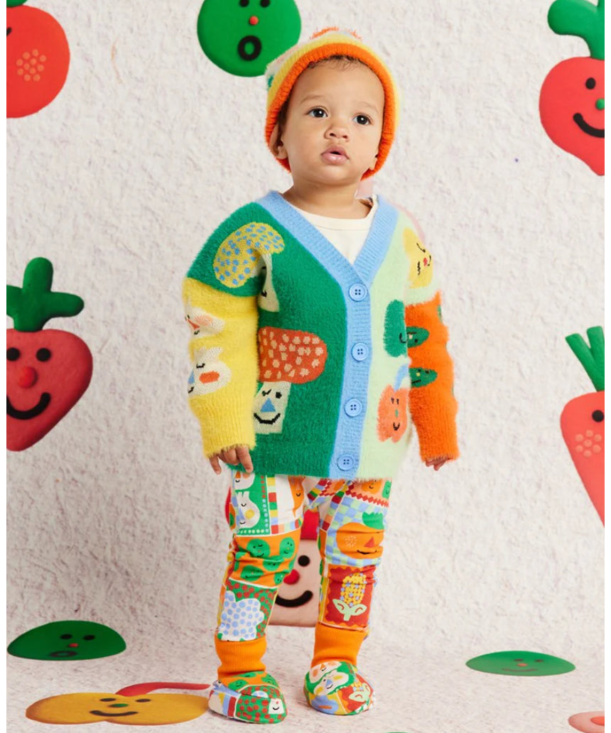 Knit baby booties with pocket patches by Halcyon Nights, paired with matching cardigan, leggings, and beanie for cozy baby clothing.