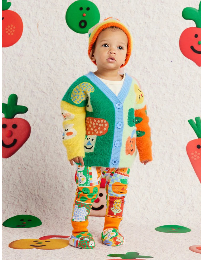Knit baby booties with pocket patches by Halcyon Nights, paired with matching cardigan, leggings, and beanie for cozy baby clothing.