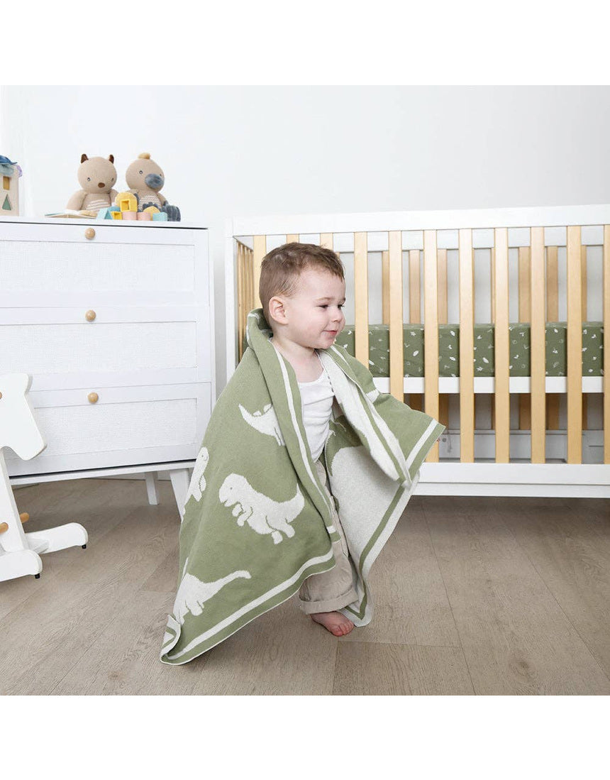 Living Textiles knitted pram blanket featuring a colorful dinosaur pattern, perfect for keeping babies warm and cozy.