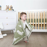 Living Textiles knitted pram blanket featuring a colorful dinosaur pattern, perfect for keeping babies warm and cozy.
