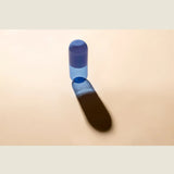 Maho Happi Pill into the Blue glassware with blue and clear design, featuring a cylindrical shape and decorative pattern.