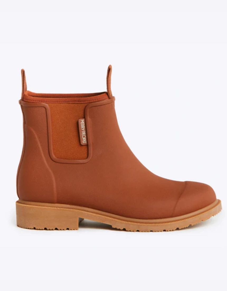 Rust-colored Merry People Bobbi Gumboot shoes with black soles and rounded toe, stylish waterproof footwear for women.