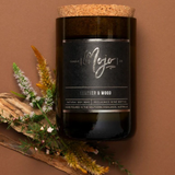 Leather and wood scented candle by Mojo Candle Co. from the Black Label collection, featuring a sleek black container.