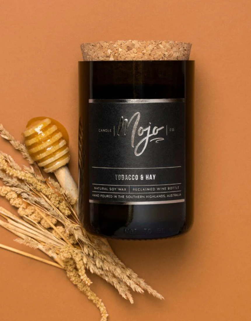 Mojo Candle Co. Tobacco & Hay Black Label candle with black label and rustic wax finish.
