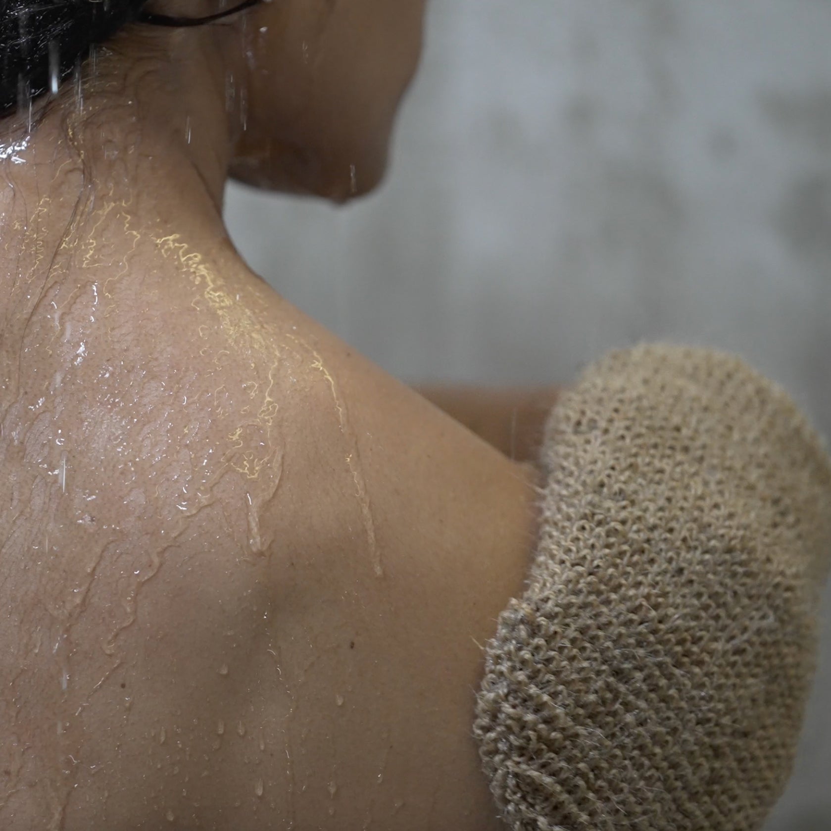 Salus Body exfoliation mitt for body scrubbing, soft fabric with textured surface for smooth skin in bath or shower.