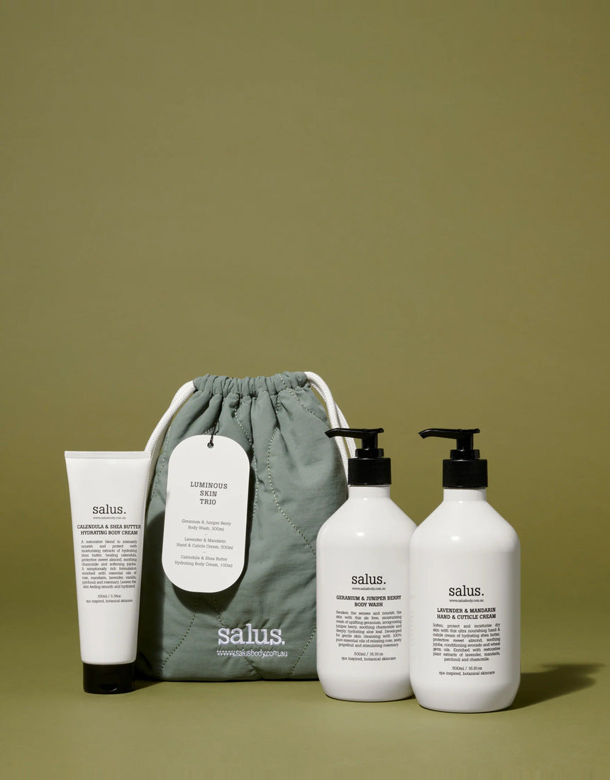Salus Luminous Skin Trio gift set with skincare products displayed in a lifestyle setting, highlighting luminous, radiant skin.