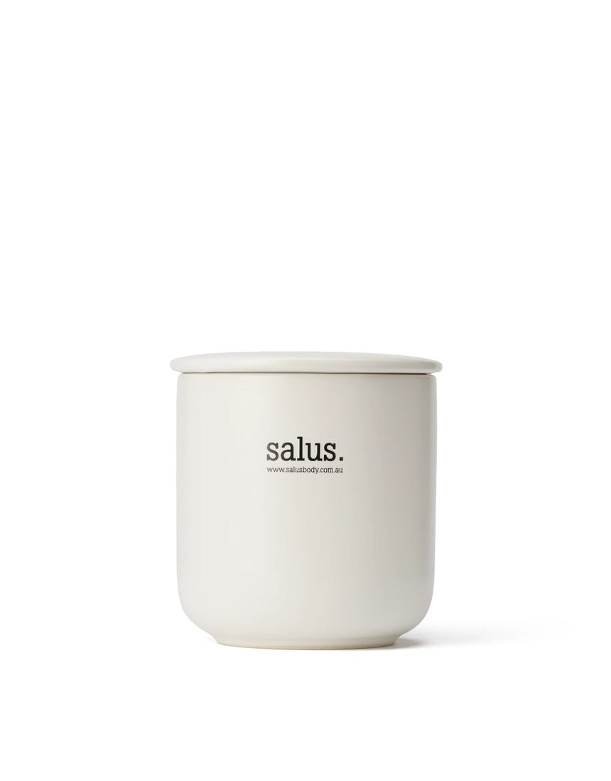 Salus Rose Geranium Soy Candle with 55-65 hour burn, featuring a glass jar and floral label, ideal for relaxing home ambiance.