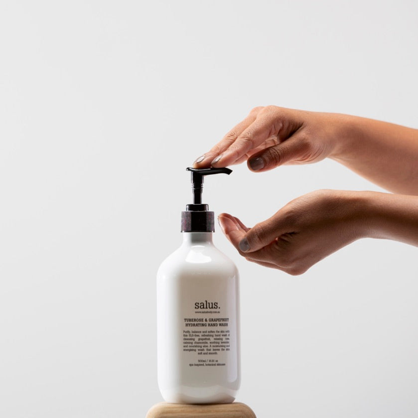 Salus Tuberose & Grapefruit Hydrating Hand Wash bottle showing clear liquid with floral and citrus scent label.