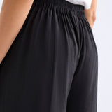 Black Elk Rema Pant showing slim-fit design and adjustable waistband, made from comfortable fabric, casual style pants.
