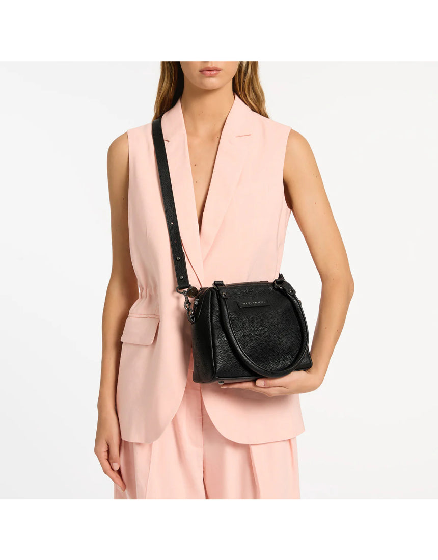 Black Status Anxiety Mini Mountains Bag with adjustable strap and compact design, ideal for casual everyday use.