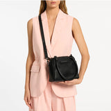 Black Status Anxiety Mini Mountains Bag with adjustable strap and compact design, ideal for casual everyday use.