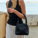 Black Status Anxiety Mini Mountains Bag with adjustable strap, featuring a compact design and stylish details.