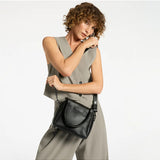 Black Status Anxiety Mini Mountains Bag shown with adjustable strap and compact design, perfect for casual everyday use.