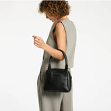 Black Status Anxiety Mini Mountains bag with compact design and adjustable strap, suitable for casual outings and everyday use.