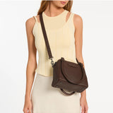Status Anxiety Mini Mountains Bag in cocoa color with adjustable strap, stylish small bag featuring mountain-inspired design.