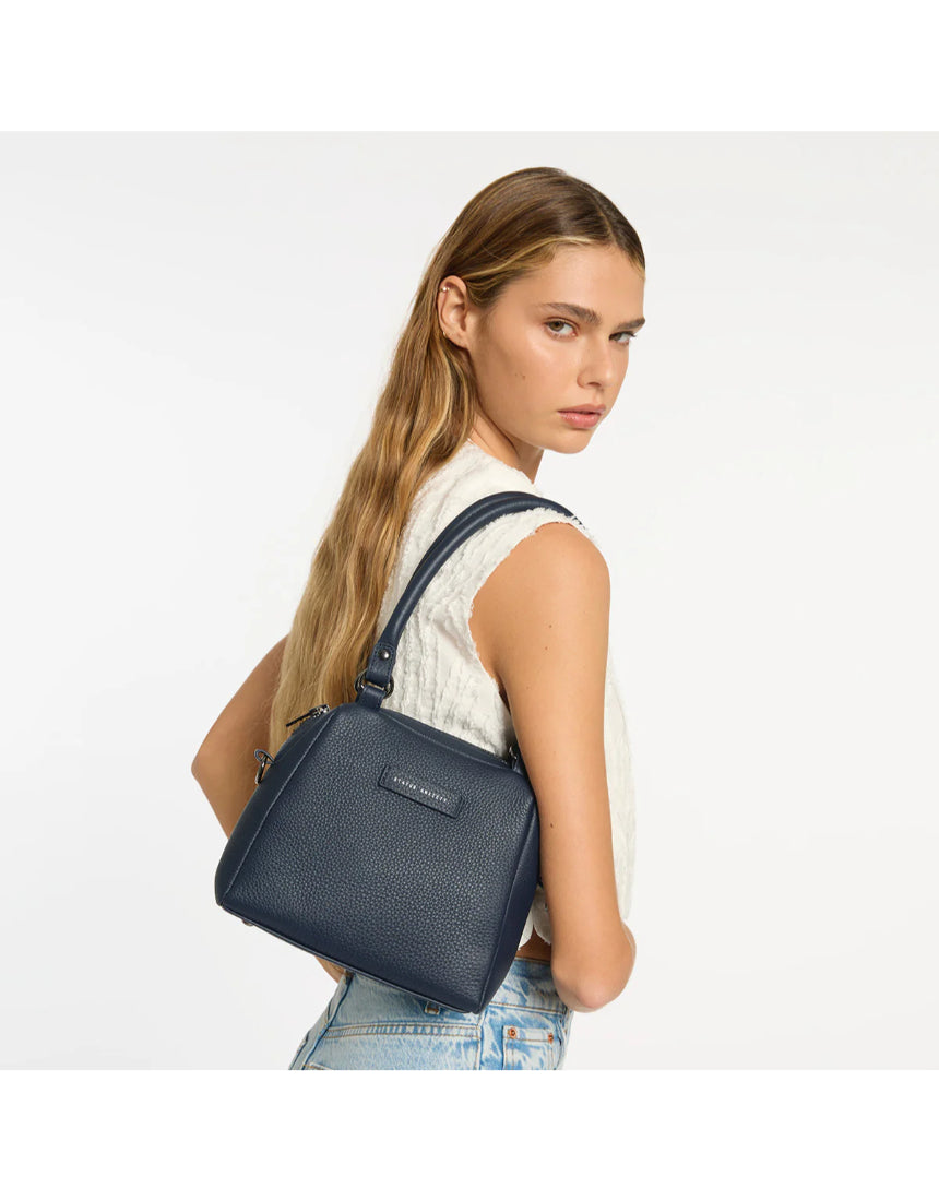 Status Anxiety Mini Mountains Bag in midnight blue, stylish compact bag with adjustable strap and mountain-inspired design.
