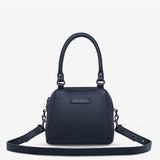 Mini Mountains Bag by Status Anxiety, midnight blue leather bag with minimalist mountain design, front view.