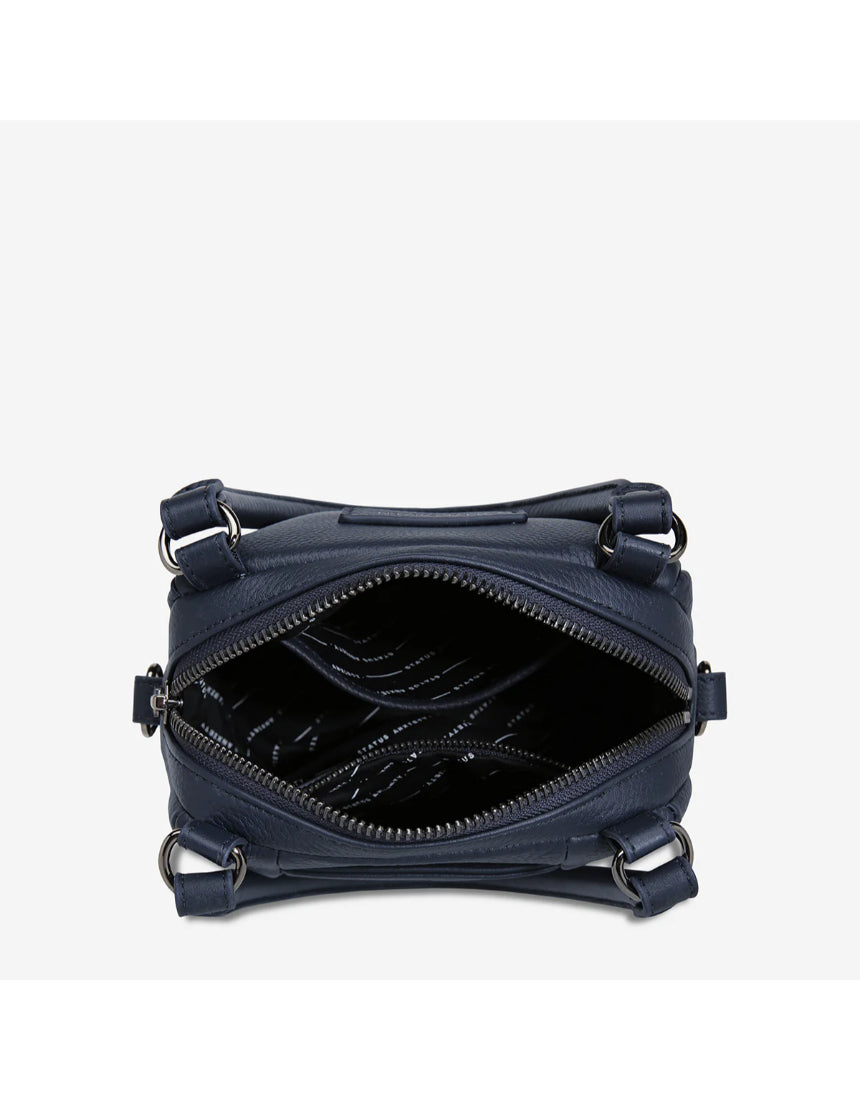 Open midnight blue Status Anxiety Mini Mountains bag showing its compact design and stylish leather strap.