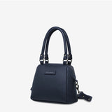 Status Anxiety Mini Mountains bag in midnight blue, side and front view showing compact bags with mountain-inspired design.