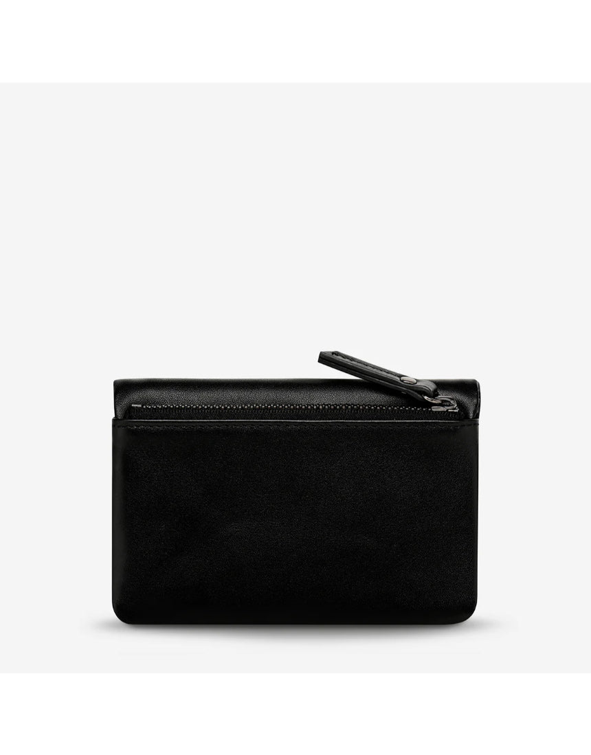Black Status Anxiety Is Now Better Wallet with smooth leather finish, featuring multiple card slots and a sleek, modern design.
