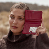 Status Anxiety Is Now Better wallet in rouge, featuring a sleek design and multiple card slots, perfect for everyday use.