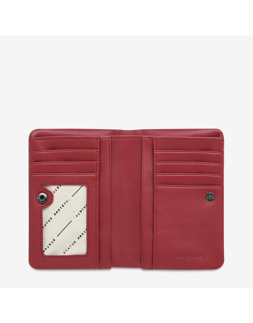 Open Status Anxiety Is Now Better Wallet in rouge, showing smooth leather exterior and organized interior compartments.