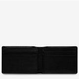 Black Status Anxiety Jonah wallet with minimalist design, featuring a smooth leather finish and compact structure for everyday use.