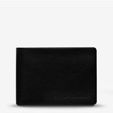 Black Status Anxiety Jonah Wallet with front view, showcasing its sleek design and compact wallet features.