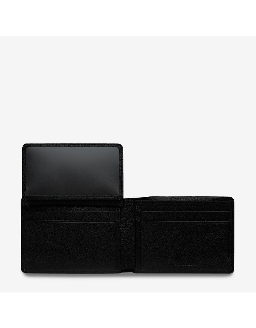 Open Status Anxiety Jonah wallet in black showing card slots and cash compartment, made of durable leather.