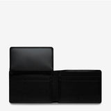 Open Status Anxiety Jonah wallet in black showing card slots and cash compartment, made of durable leather.