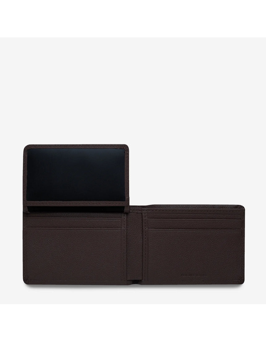 Open Status Anxiety Jonah Wallet in chocolate brown showing card slots and interior details. Stylish men's wallet with multiple compartments.