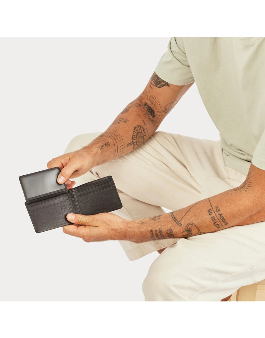 Status Anxiety Jonah Wallet in chocolate leather, featuring multiple card slots and a sleek, compact design.