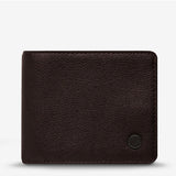Status Anxiety Leonard Wallet in chocolate brown with a sleek leather design, featuring multiple card slots and a secure fold-over closure.