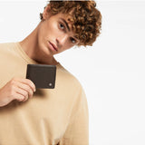 Status Anxiety Leonard wallet in chocolate leather showing multiple card slots and sleek design.