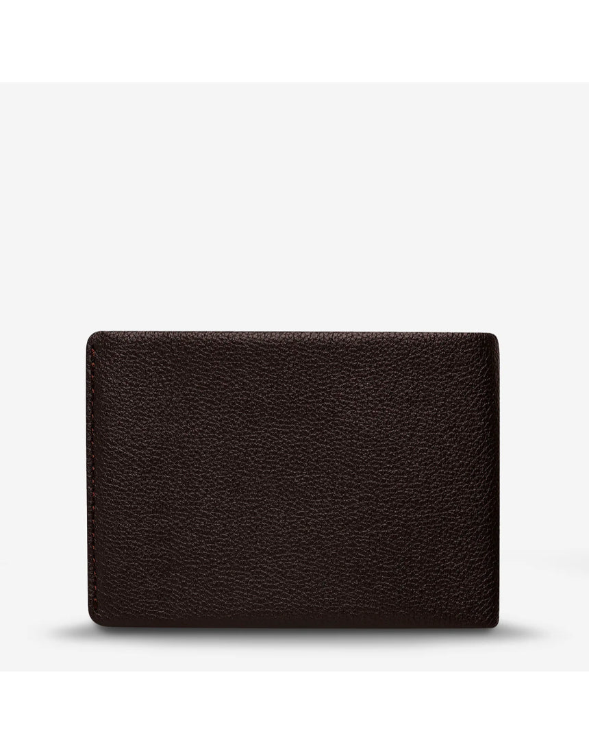 Status Anxiety Otis Wallet in chocolate brown, showcasing a sleek leather design with multiple card slots and a minimalist style.