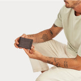 Status Anxiety Otis Wallet in chocolate color showing multiple card slots and sleek leather design.